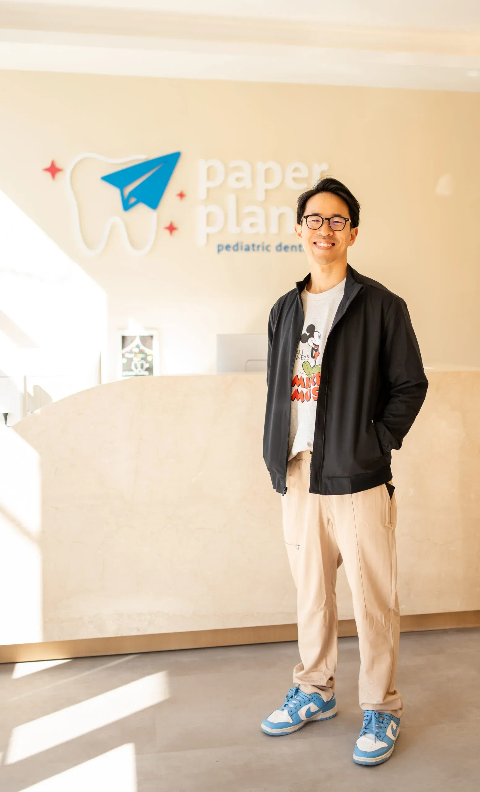 The Portrait of Dr. Christopher Pae, showcasing trusted pediatric dentist and professional expertise at Paper Planes.